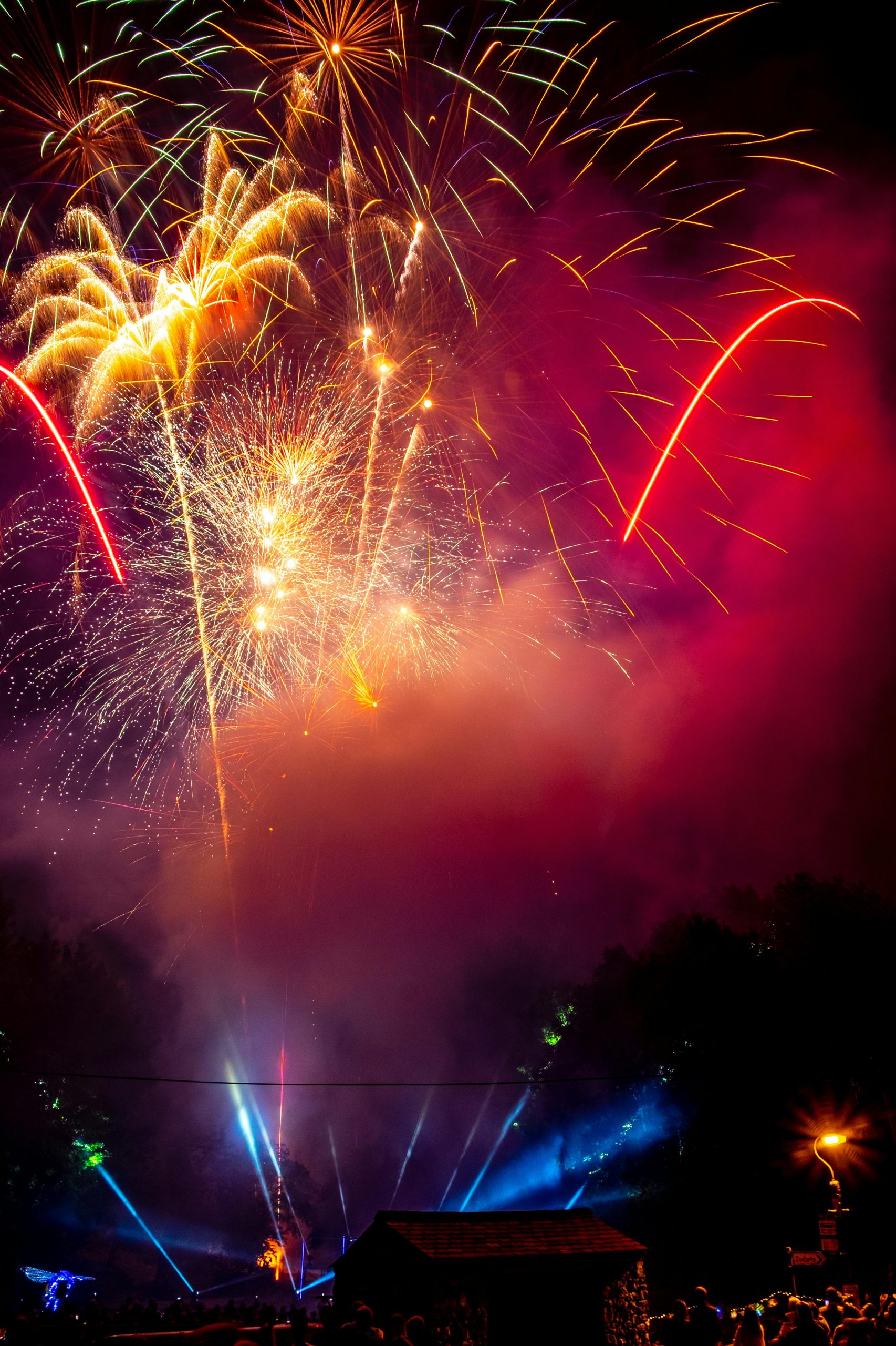 A dazzling explosion of colorful fireworks lighting up the night sky during a festive celebration.